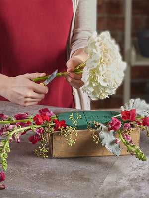 Florist using Oasis Standard Floral Foam to make an arrangement