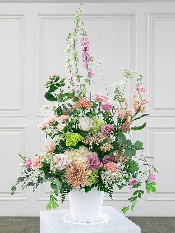 Round white plastic basket with pink flowers