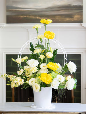 Round white plastic basket with yellow flowers