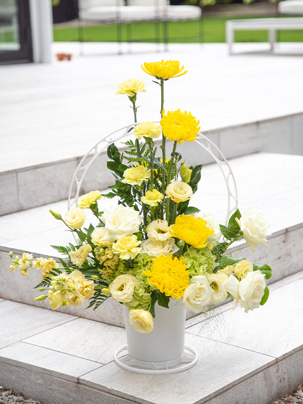 Round white plastic basket with yellow flowers